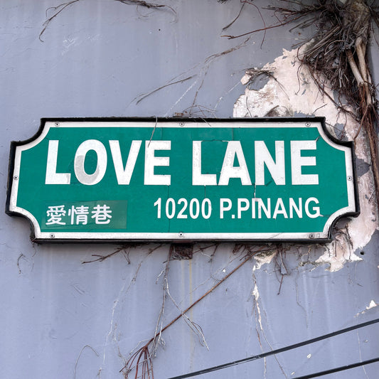 Sign saying ‘Love Lane’ on a weathered wall