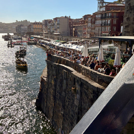 scenic view of people dining on a rock face overlooking the Douro river